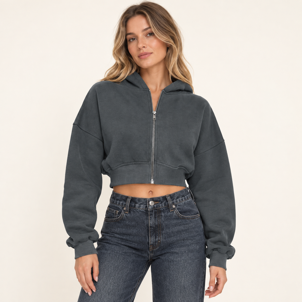 Gray women's cropped full-zip hoodie, front view on a synthetic adult model