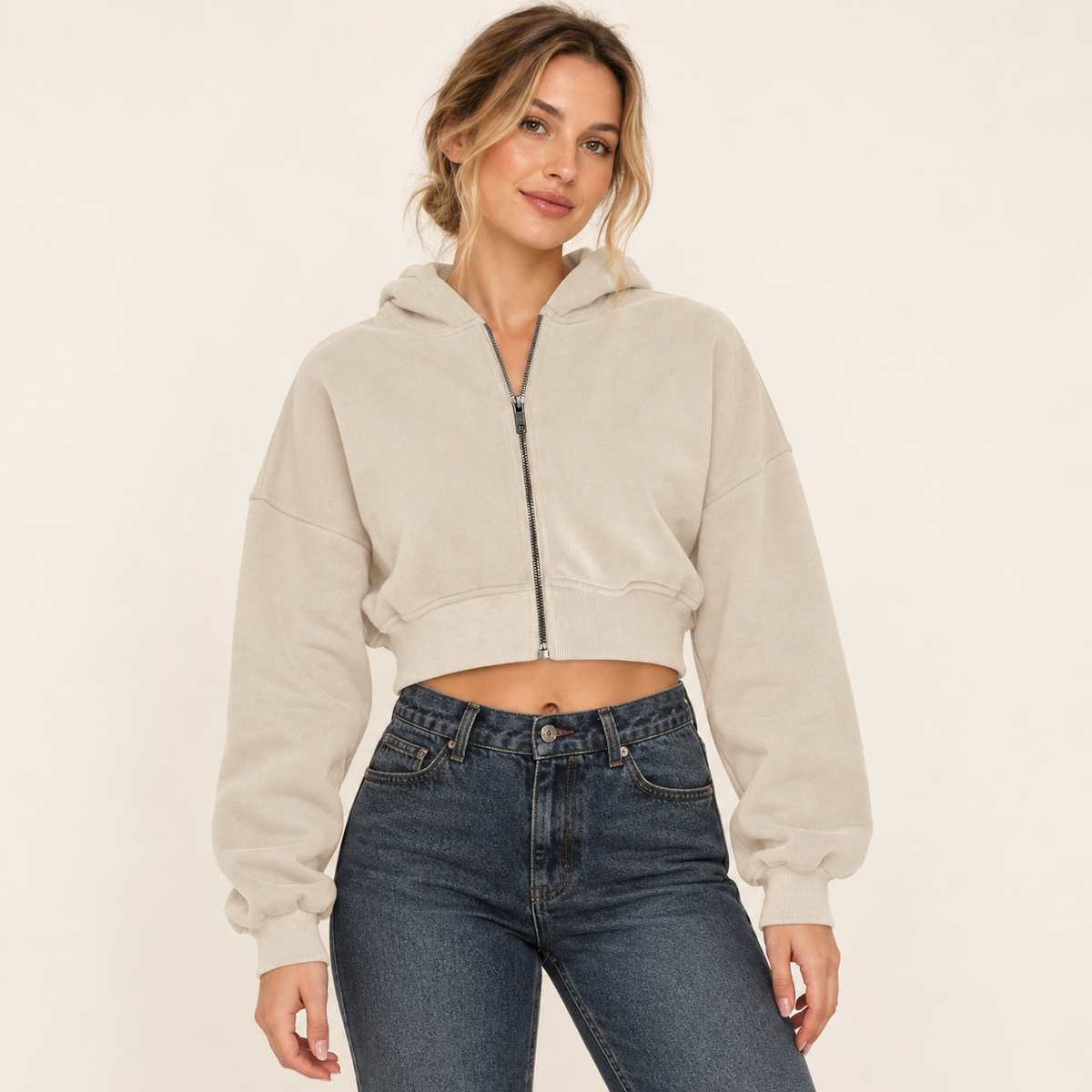 Beige women's cropped full-zip hoodie, front view on a synthetic adult model