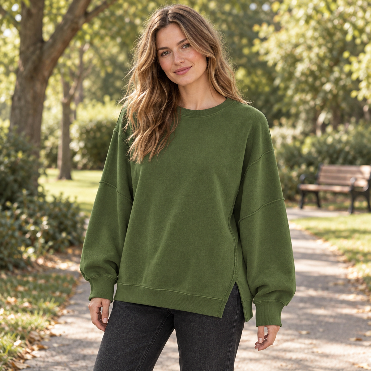 Olive Green women's oversized split-hem sweatshirt on a park path on a synthetic adult model