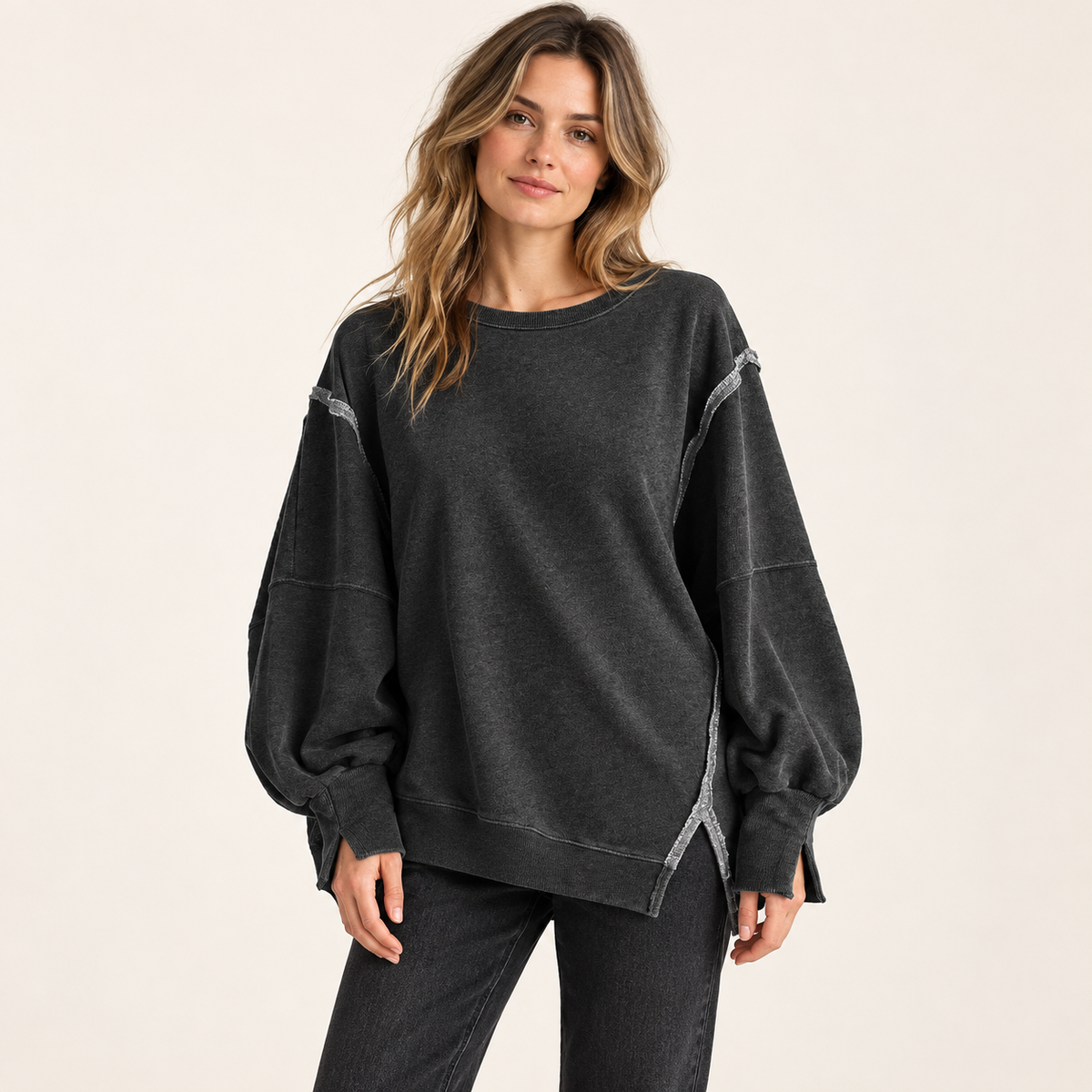 Charcoal women's oversized split-hem sweatshirt, front view on a synthetic adult model