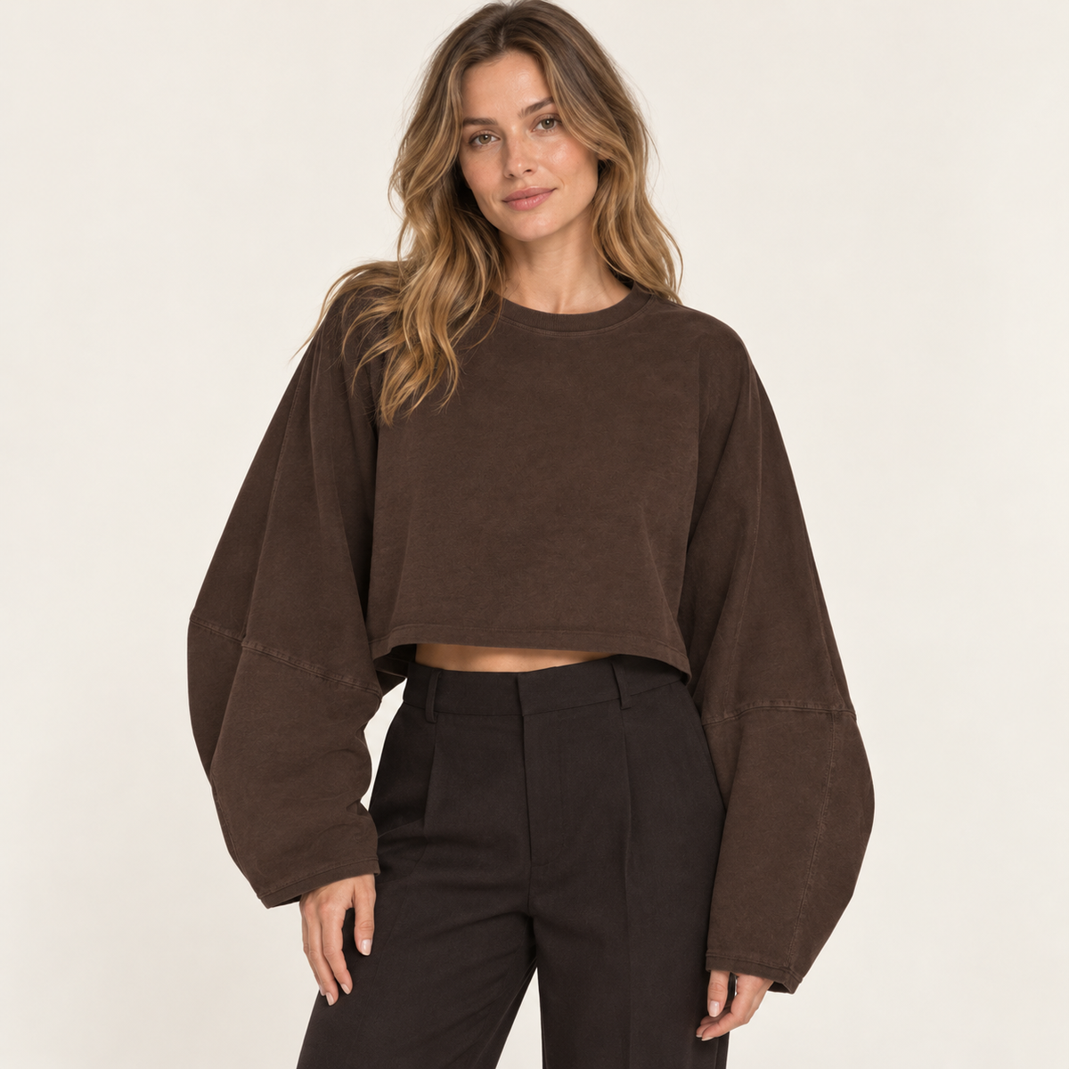 Brown women's wide-sleeve cropped sweatshirt, front view on a synthetic adult model