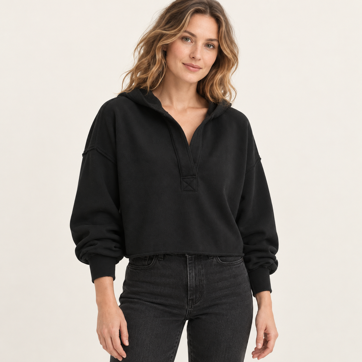 Black women's cropped V-neck hoodie, front view on a synthetic adult model