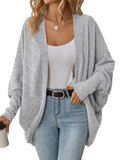 Light gray open-front batwing knit cardigan on a model, with ribbed cuffs and a draped hem