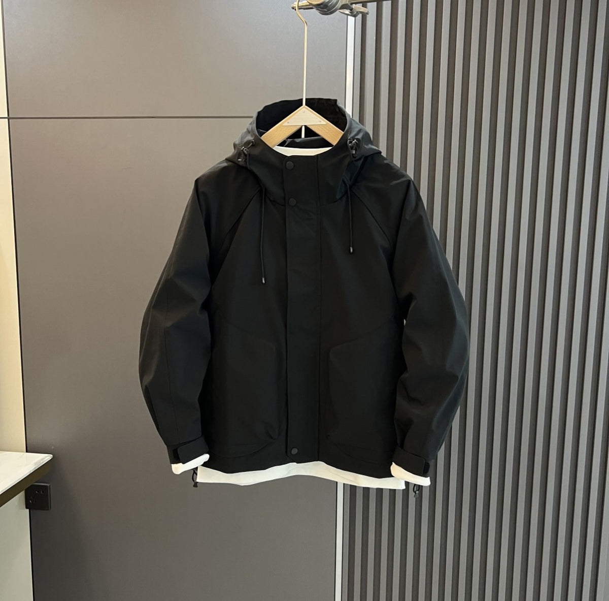AZUKI Black hooded casual jacket with covered placket and cuff tabs