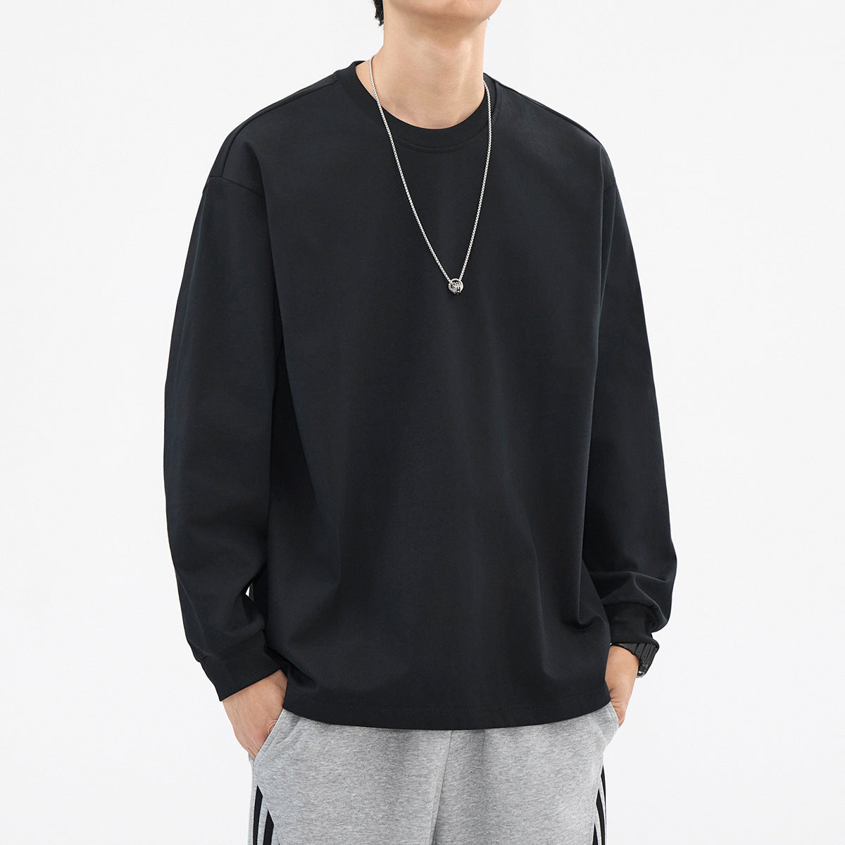 Black relaxed crewneck long-sleeve top, front view