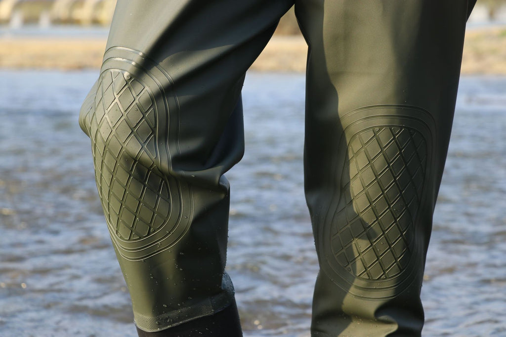 Green knee panel and stitched edges close-up.
