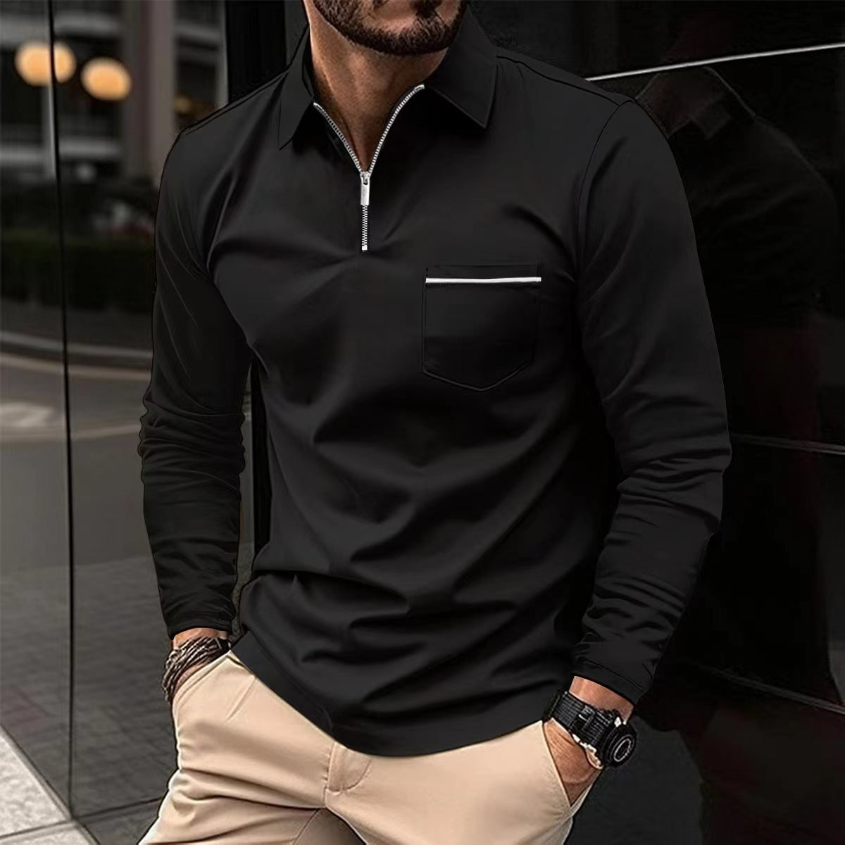 Black long-sleeve quarter-zip polo on a male model, with a contrast-trim chest pocket