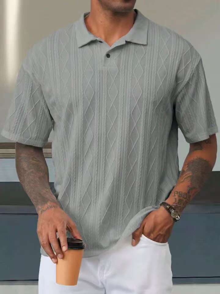 Gray geometric-textured short-sleeve polo on a male model, front view showing the collar and short placket