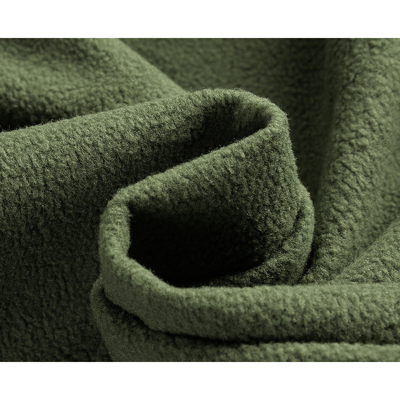Close-up of olive-green textured fabric from the AZUKI tactical jacket product gallery