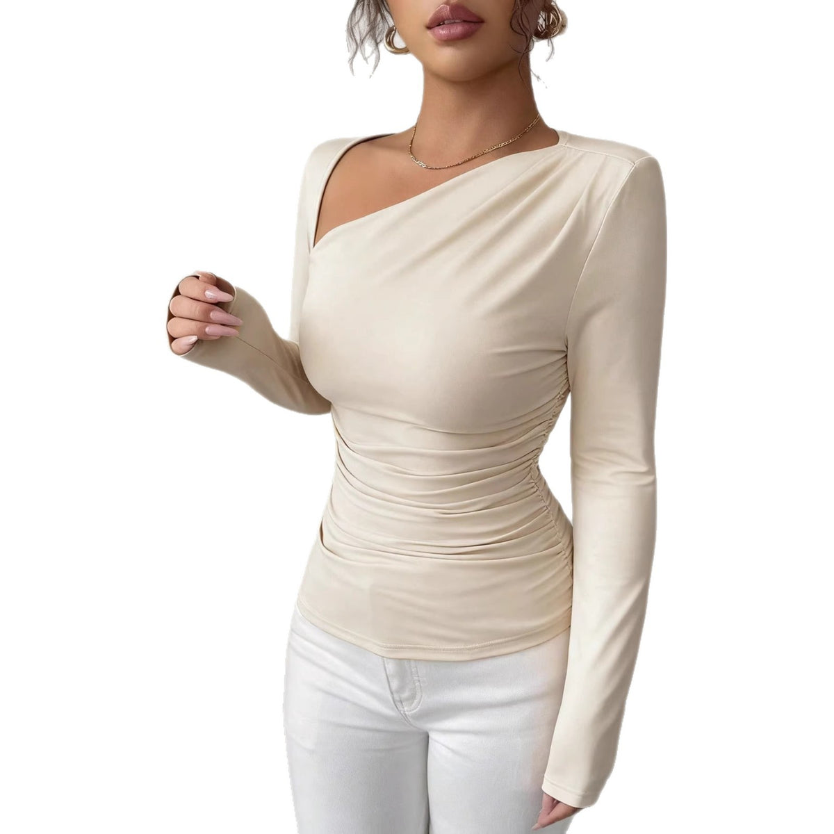 Beige long-sleeve top showing diagonal neckline and ruched waist detail