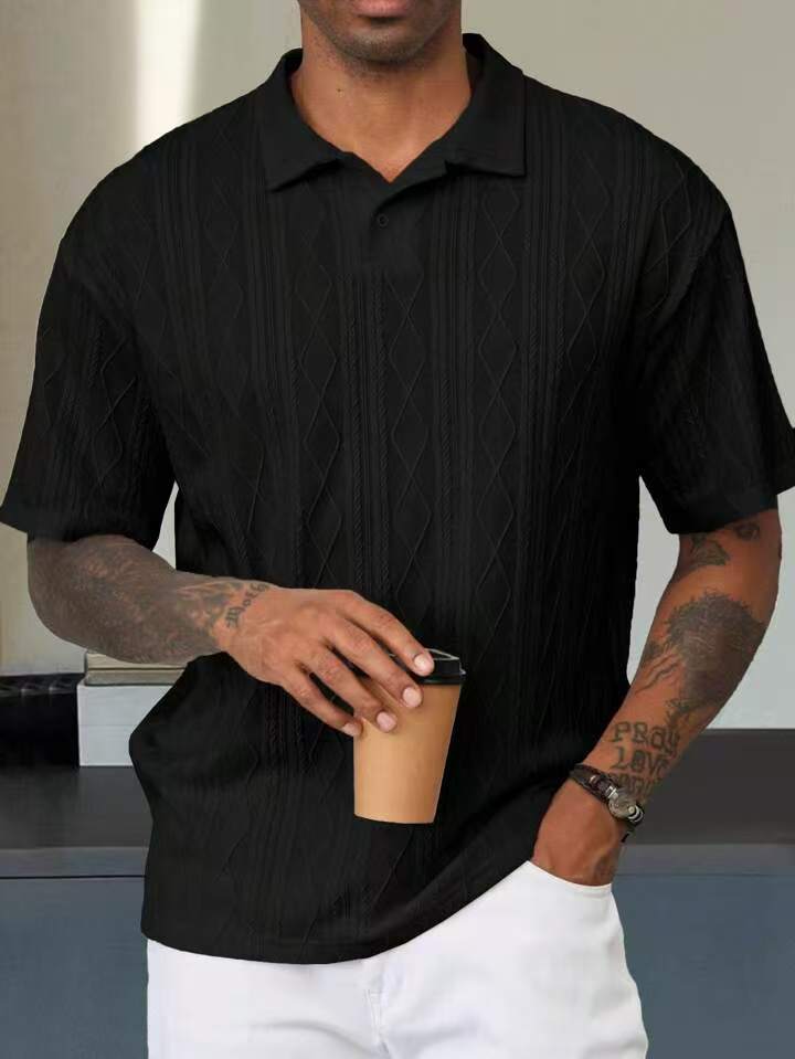 Black geometric-textured short-sleeve polo on a male model, front view showing the collar and short placket
