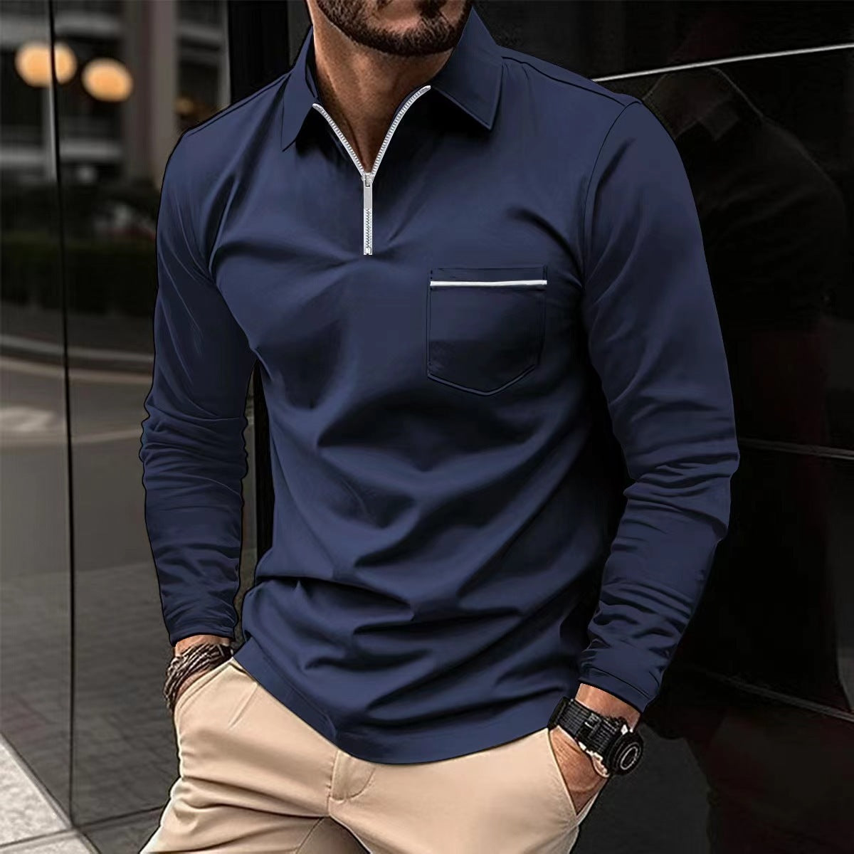 Navy long-sleeve quarter-zip polo on a male model, with a contrast-trim chest pocket