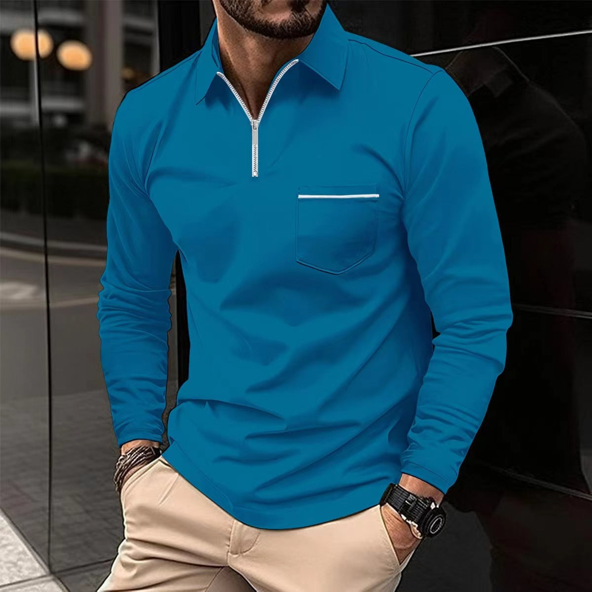 Royal blue long-sleeve quarter-zip polo on a male model, with a contrast-trim chest pocket