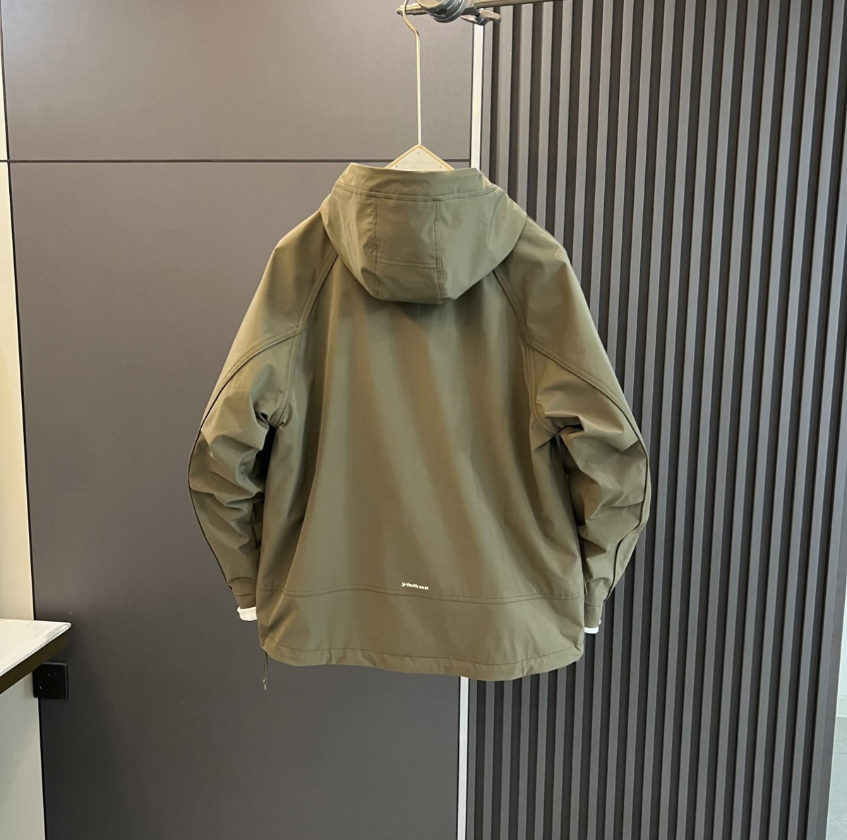 AZUKI Olive Green hooded casual jacket, back view on hanger