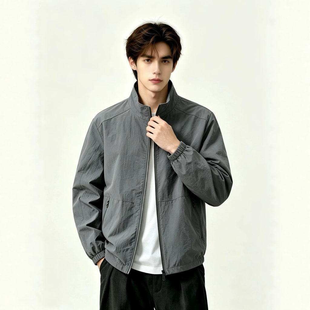 Adult model wearing the AZUKI gray stand-collar zip jacket, front view