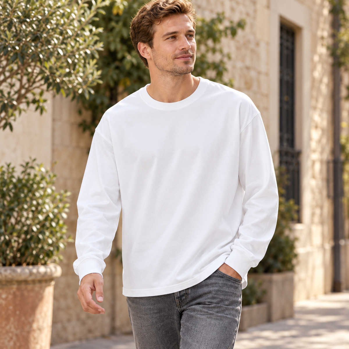 White relaxed crewneck long-sleeve top styled on a neighborhood street