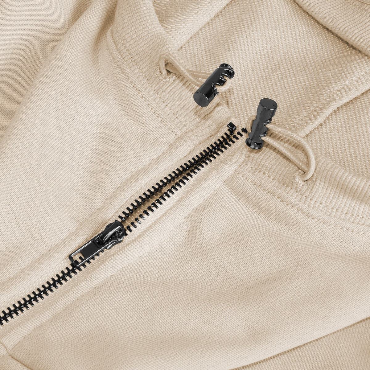 Beige half-zip hoodie, zipper and hood drawcord toggle detail