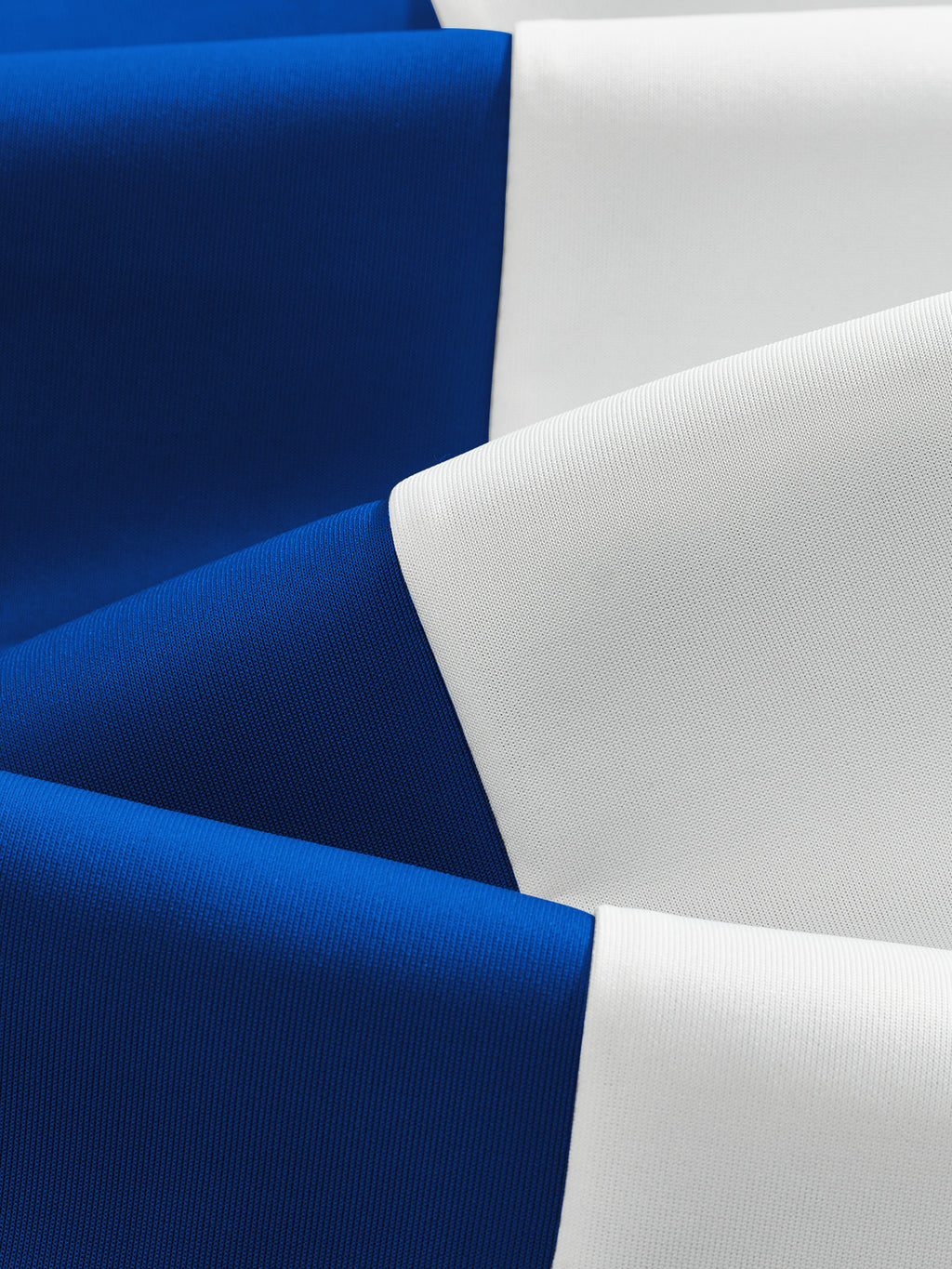 Original close-up of fine knit fabric and the blue and white colorblock seam