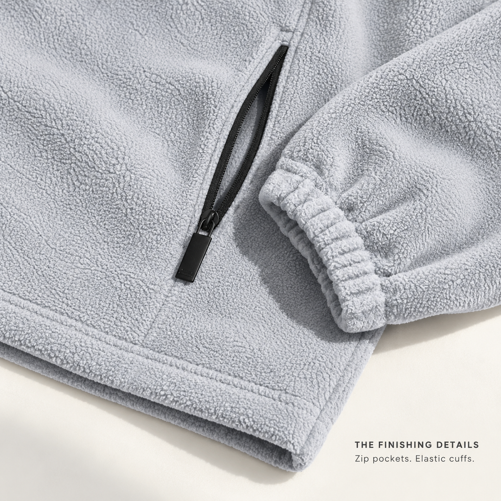 Light gray FX71 fleece zip pocket, gathered elastic cuff and stitched hem detail